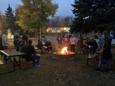 People gather around a campfire