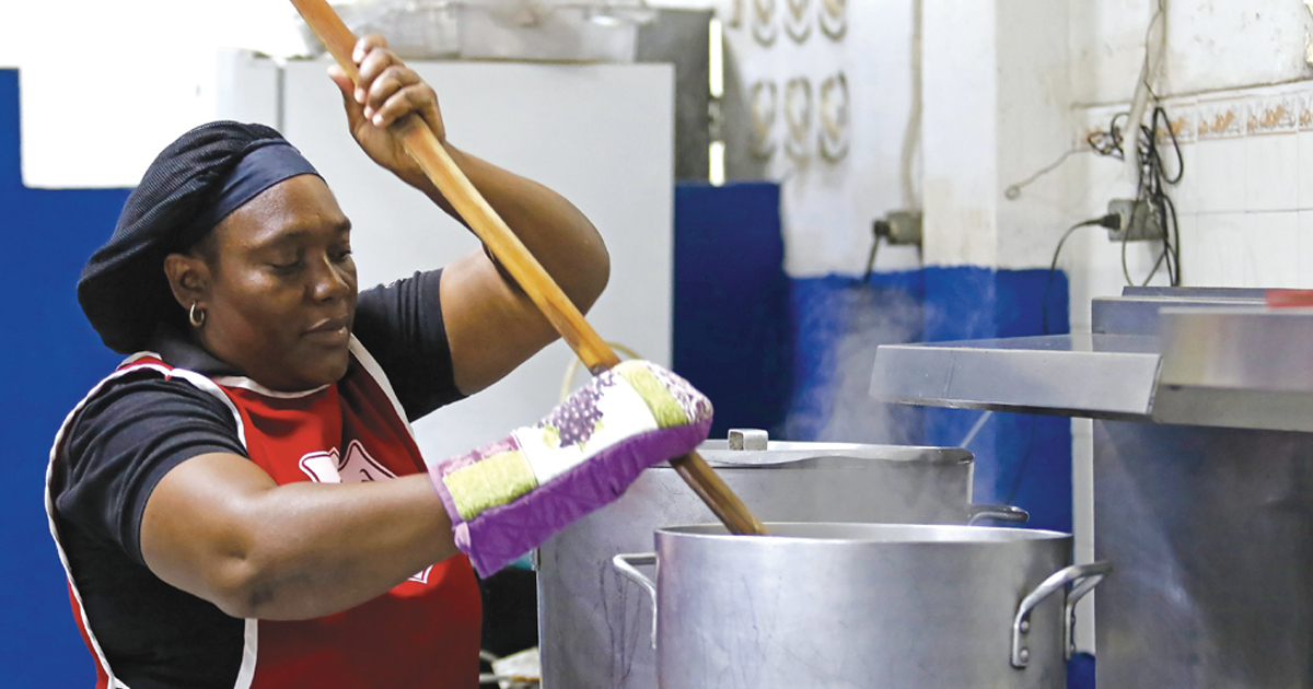 A Salvation Army employee stirs a large pot of soup