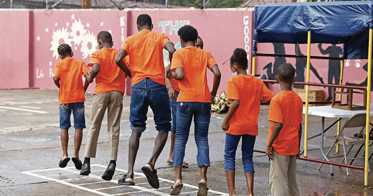Children wearing bright orange T-shirts at a playground