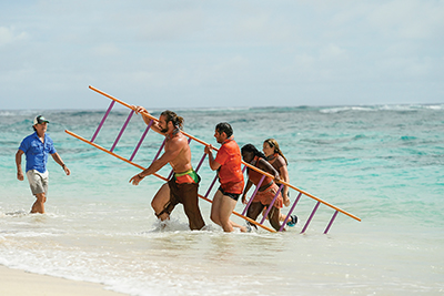 Survivor contestants including Maryanne perform a task