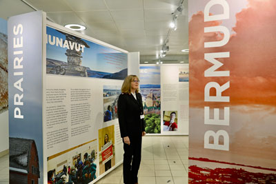 A woman walks through the IHQ exhibit