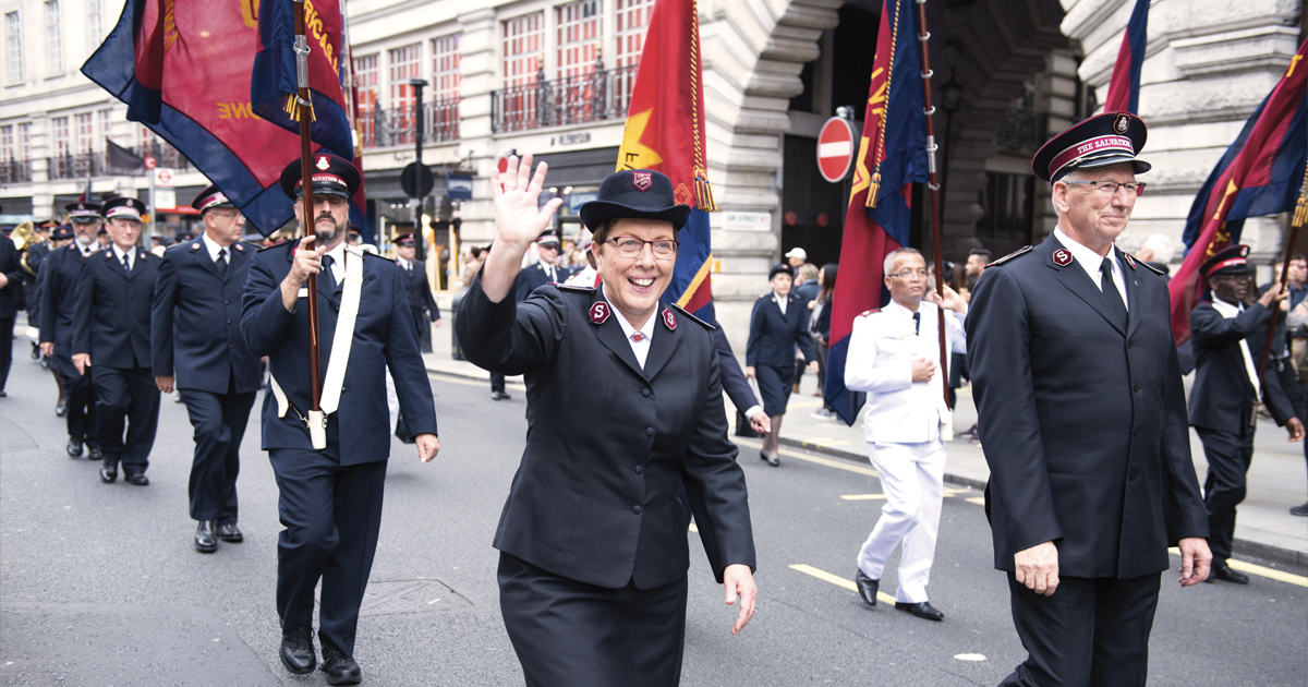 Commissioners Rosalie and Brian Peddle, then World Secretary for Women’s Ministries and Chief of the Staff, march through the streets of London, England, during The Whole World Mobilising celebration in October 2017