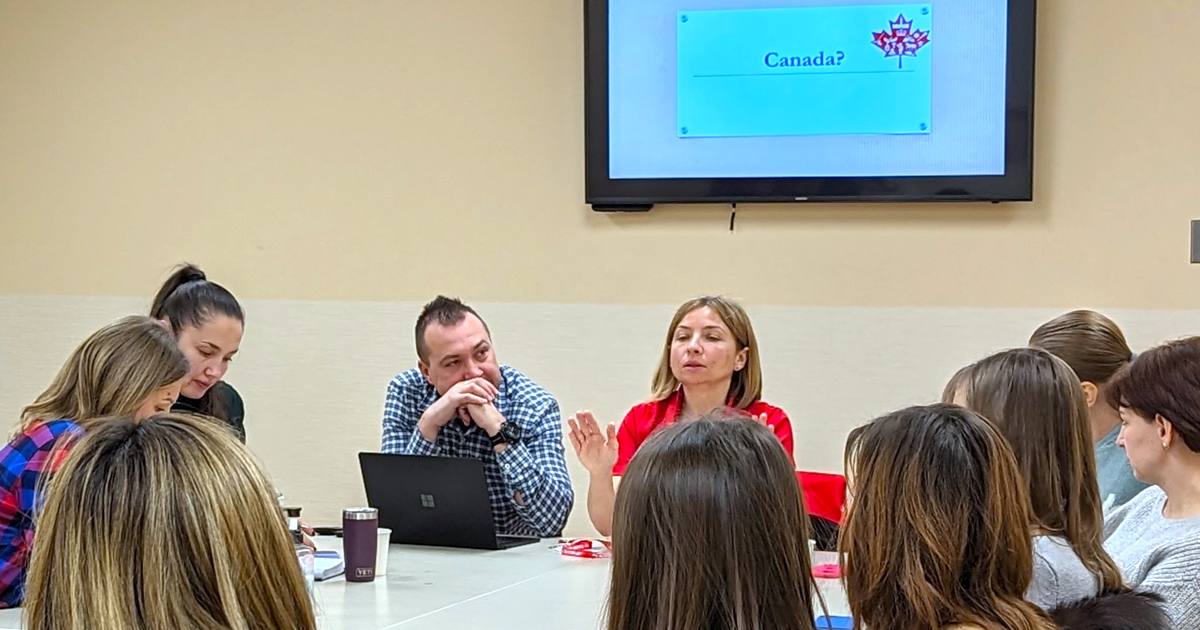At the Ukrainian welcome centre, Maryna Skorobogatko (centre) hosts meetings for newcomers to learn about Canada and share their stories