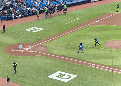 General Brian Peddle throws the first pitch at a Toronto Blue Jays game for Salvation Army Night