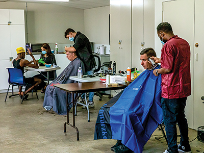 Free haircuts being provided to the clients.