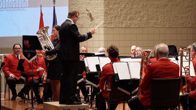 A brass band performing with a soloist