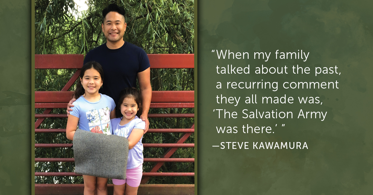Steve Kawamura stands with his two daughters, Kohana and Minako, holding the family blanket