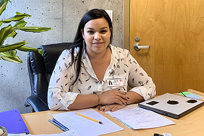 Jenea Gomez at her desk