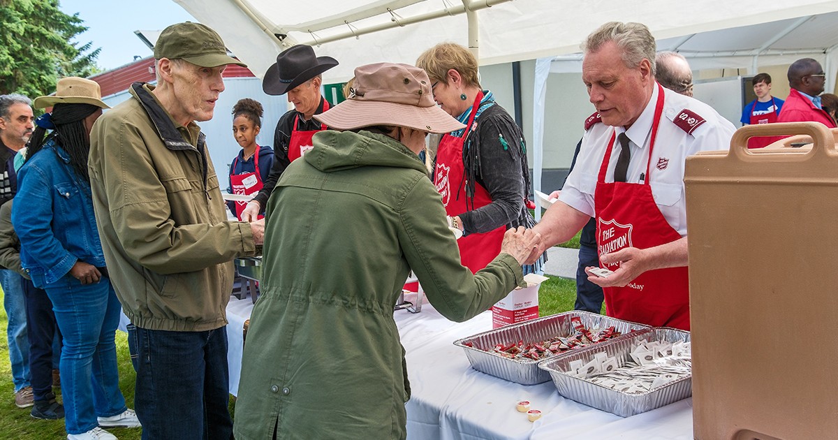 A man serves breakfast to people