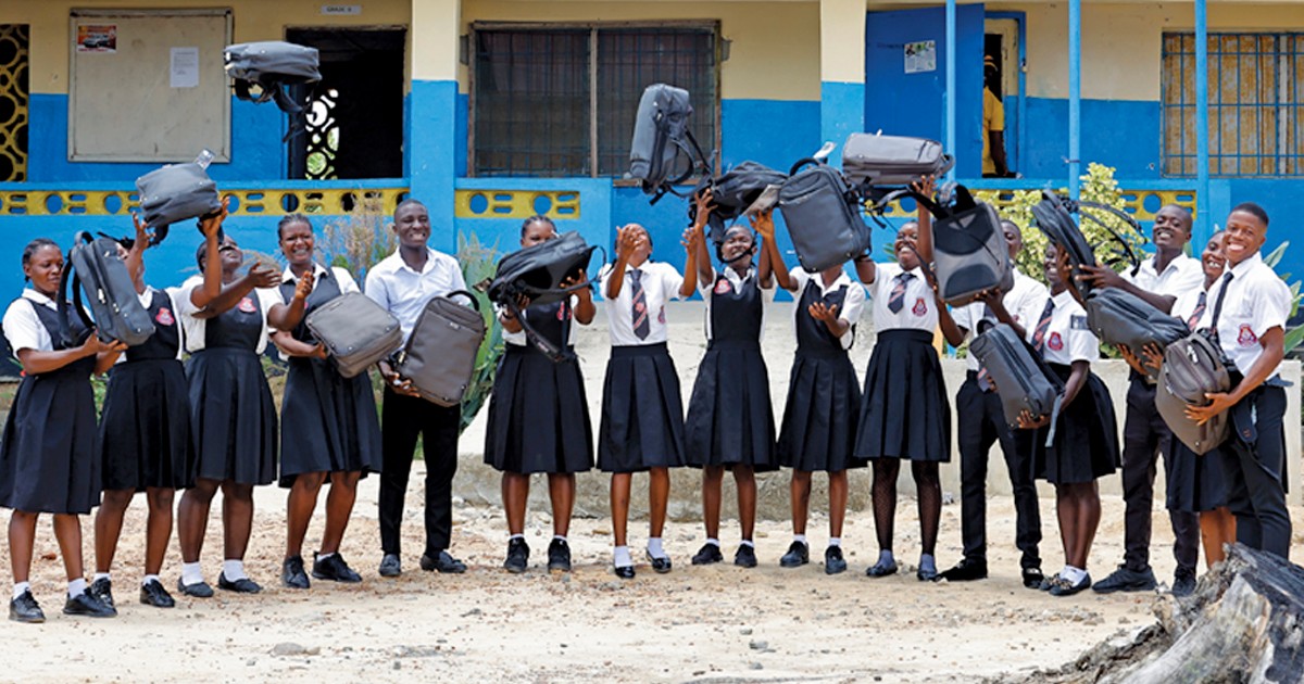 A group of students holding backpacks