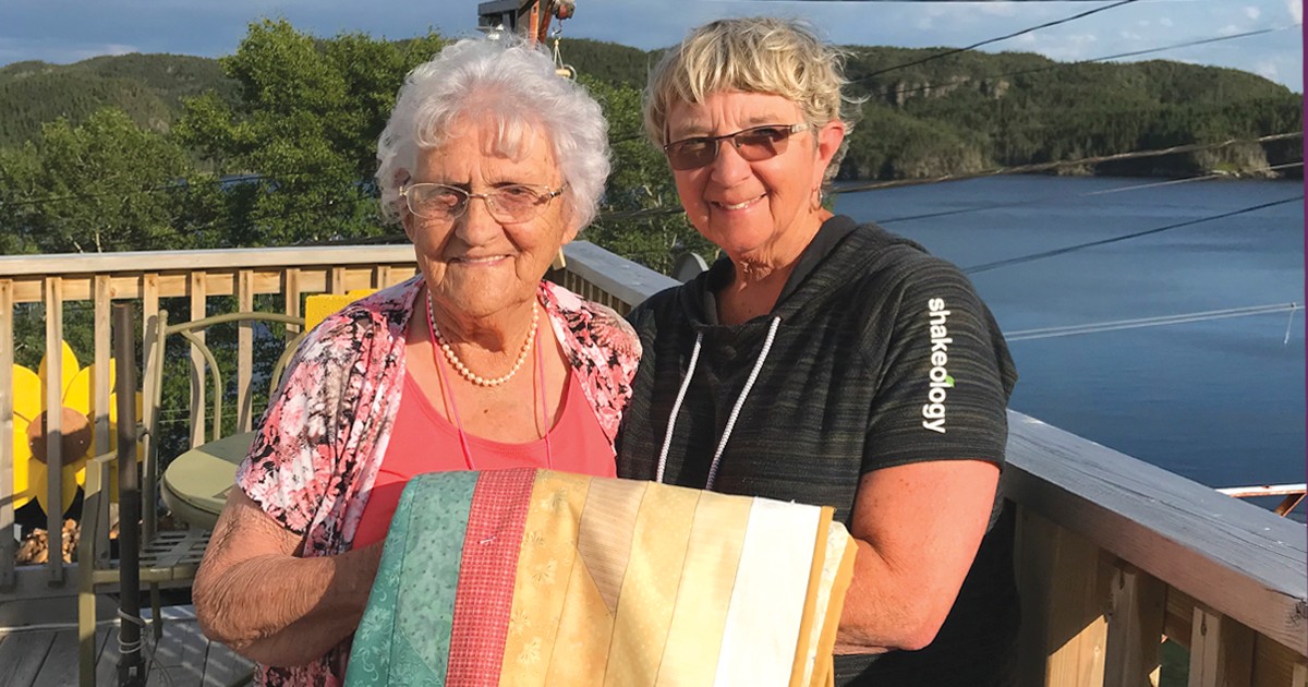 Two women holding a blanket