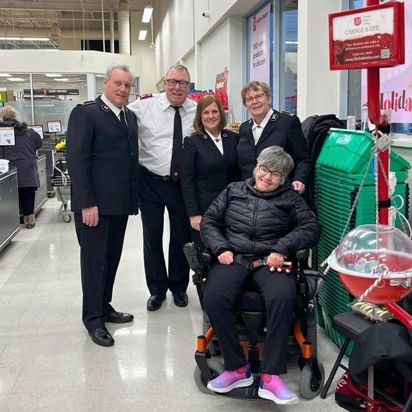 A group of people at a Salvation Army kettle