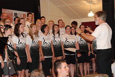 Ballantine leads a choir of young people