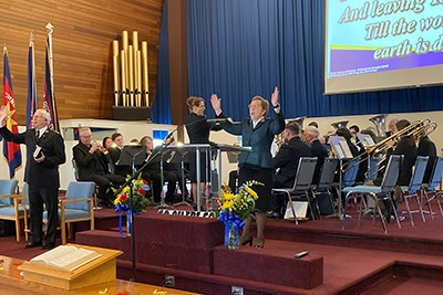 Comr Peddle leads a song at the Sunday morning anniversary service at Corner Brook Temple