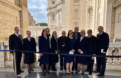 A group of people stand together at the Vatican