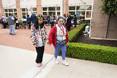 Natalie (right) holding hands with a friend