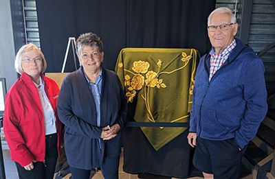 From left, Mjr Donna Millar, Marilyn and Bram Hurd with the tablecloth display