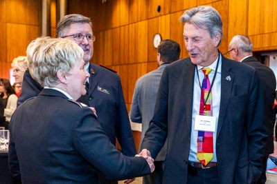 Colonel Wendy Swan shakes hands with John McKay