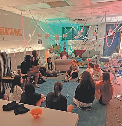 Girls sitting in a circle on the floor at Woven in Toronto