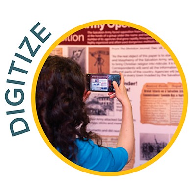 Digitize - a person takes a photo of a display