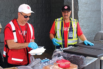 Two EDS volunteers serve hot meals