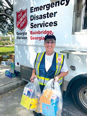 Volunteer with a bag of children's toys