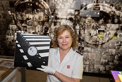 Major Kathy Versfeld holding Give Peace a Chance vinyl