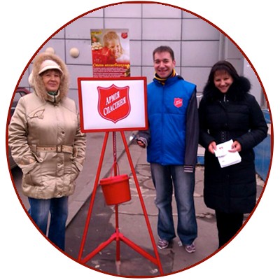 Volunteers stand at a Salvation Army Christmas kettle