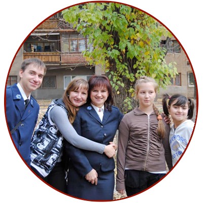 Iryna (middle) with smiling youth