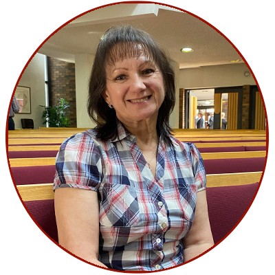 Iryna sitting in a church pew