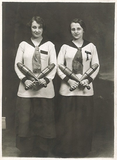 Two young women holding Indian clubs