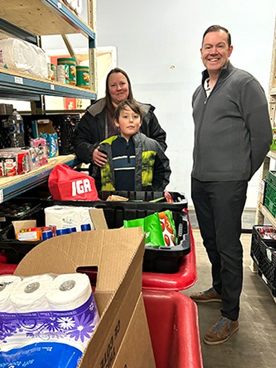 Hunter and his mother, Jolene, at the food bank with Jared Braun, executive director of The Salvation Army in Fort St. John, B.C.