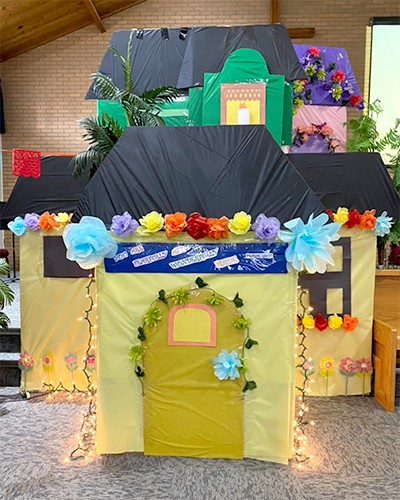 The colourful casita (house), covered in flowers and twinkling lights, from Encanto