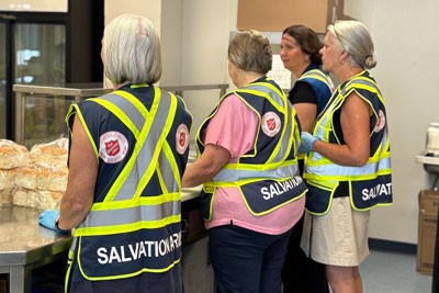 Salvation Army volunteers serving in a line