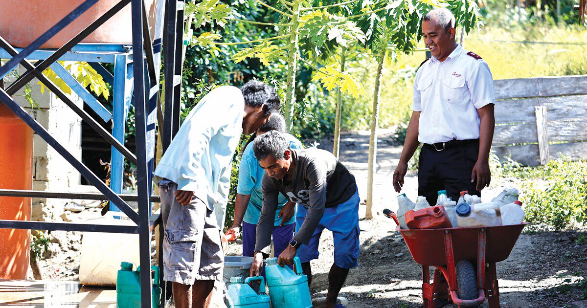 A member of the Anugerah Tandau Outpost, has come to the newly constructed water point to collect water 