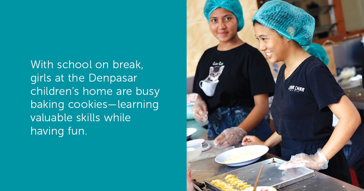 Girls from the Denpasar children’s home bake cookies. 