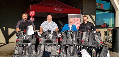 Mjr Brushett with representatives from the Yellowknife Co-op, who partnered with The Salvation Army for a Thanksgiving food drive