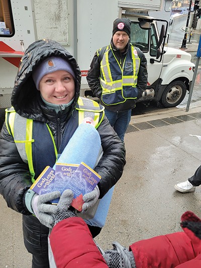 Street ministry volunteers hand out Bibles and blankets