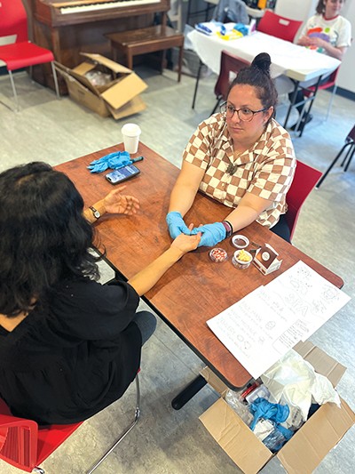 A woman giving another woman a manicure