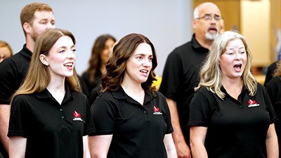 Three women singing in a group