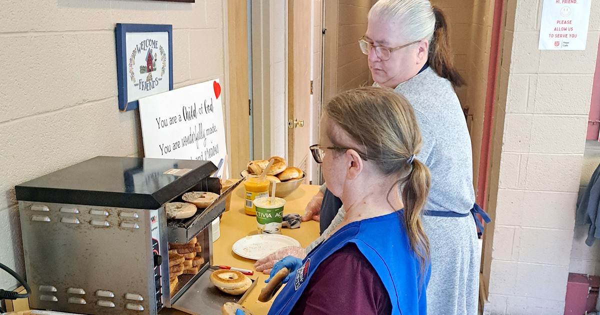 Volunteers serve hot coffee and bagels at Hope Café, a breakfast program at Saint John Hope CC
