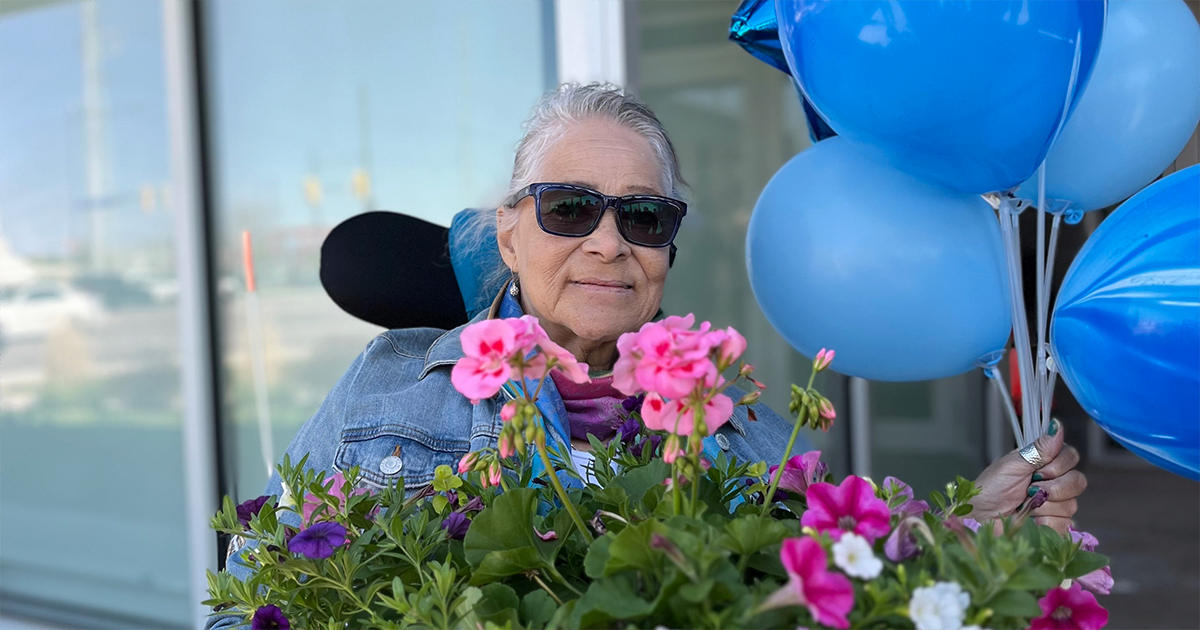 A woman with flowers and balloons