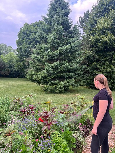 Bella Andrews waters the garden