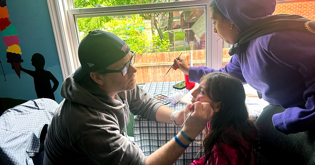 Mitch Brower paints faces at Open Arms
