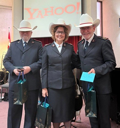 Three people wearing white cowboy hats