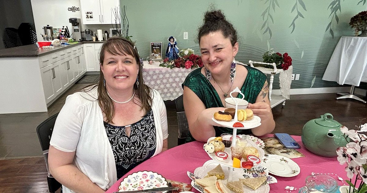 From left, Cpt Renee McFadden and Carly Butler enjoy a spread of delicious sandwiches, desserts, tea and scones at The Willows’ Victorian tea party
