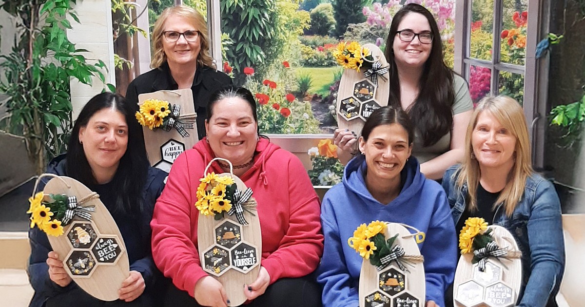 Group photo of moms with their art work
