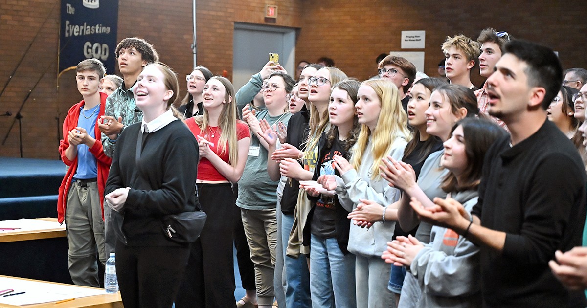 A group of young people singing 
