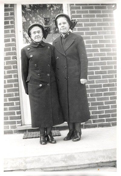 Brg Florence MacGillivray and, likely, her mother, Brg Abbie MacGillivray, on the steps of The Salvation Army’s London East Quarters, Ont., in 1956