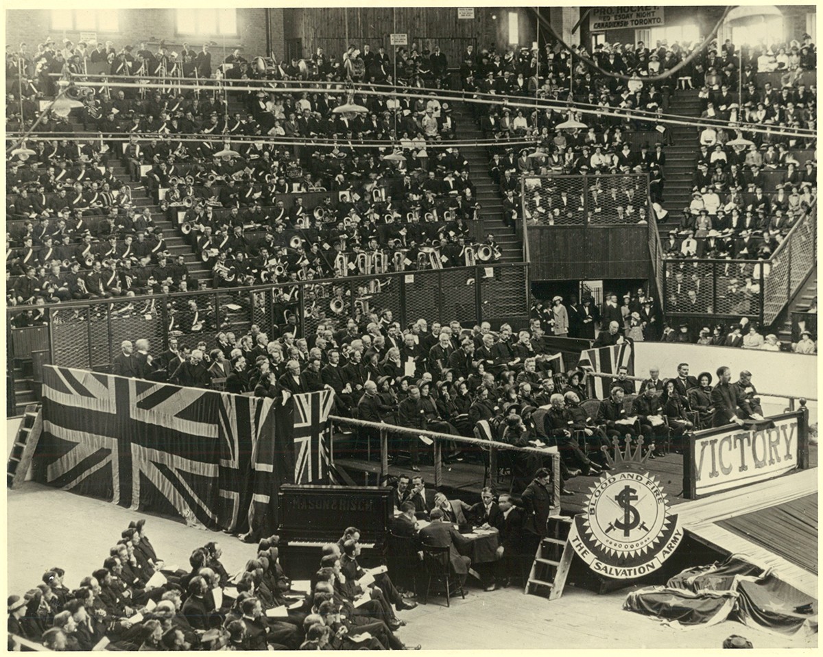 Black-and-white photo showing a large crowd at the memorial service